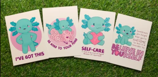 Set of 4 white cards with designs of an  teal coloured axolotl. Cards read "I've got this", "Be kind to your mind", Self-Care" and "Believe in Yourself" 