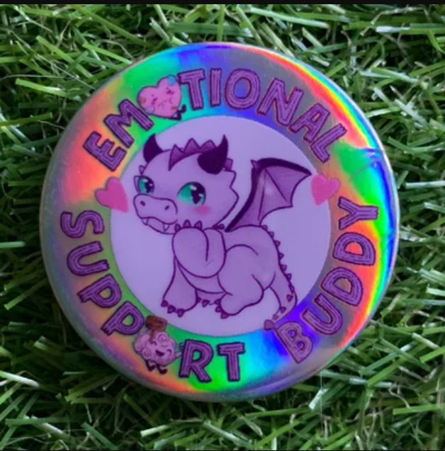 Holographic badge with a cartoon purple dragon surrounded by the text "Emotional Support Buddy"