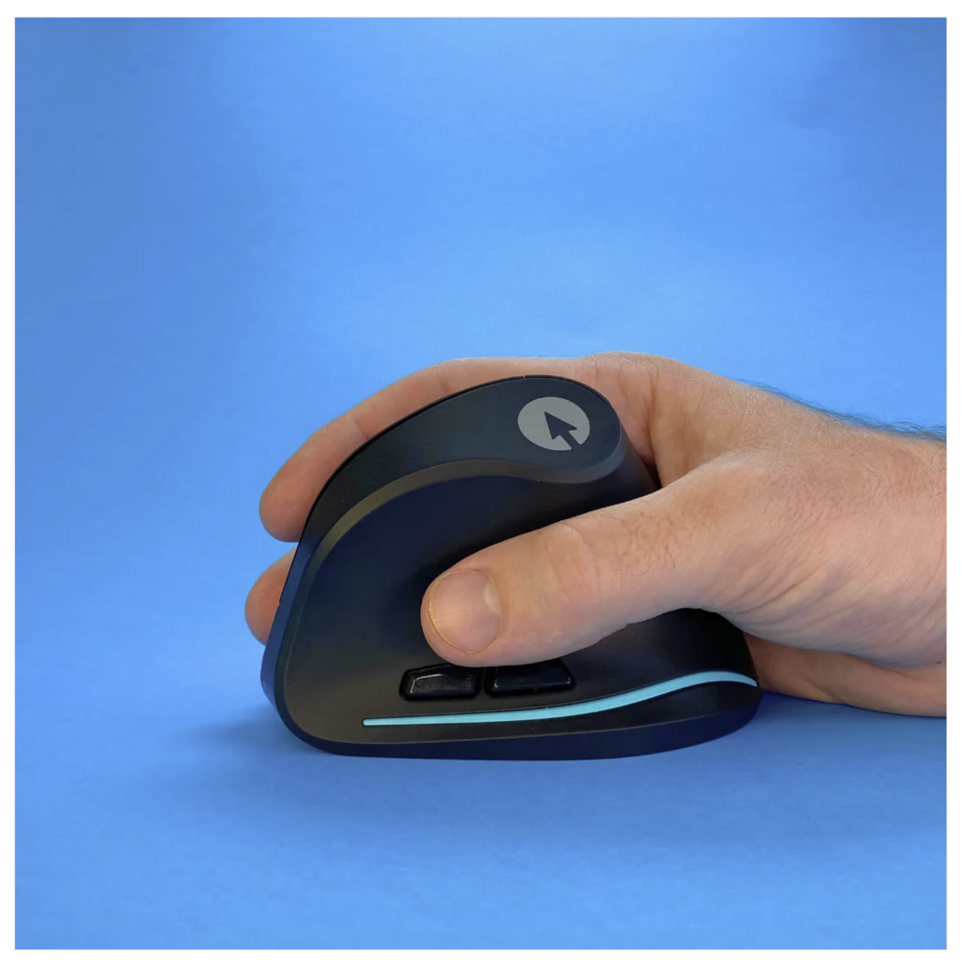 Hand dripping the Swiftpoint ergonomic vertical mouse. Two small buttons are situation near the thumb. The primary buttons are out of sight on the other side of the mouse. 
